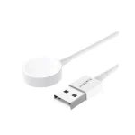 Charging a smartphone with a white magnetic wireless cable on a desk