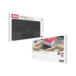 Earldom ET-KB7 slim rechargeable Bluetooth keyboard on a wooden desk next to a laptop